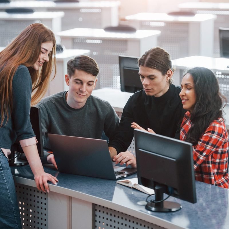 Active conversation. Group of young people in casual clothes working in the modern office.